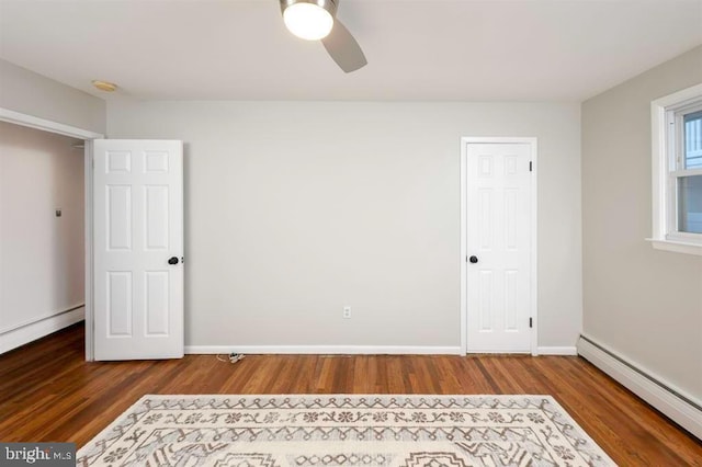 unfurnished bedroom featuring a baseboard radiator, wood-type flooring, and ceiling fan