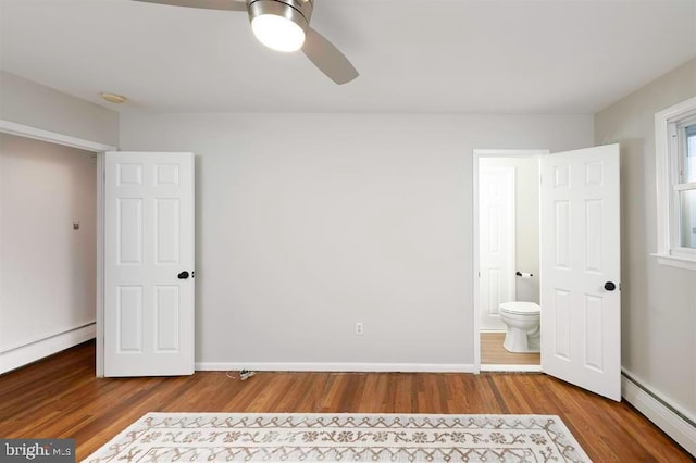 unfurnished bedroom featuring baseboard heating, hardwood / wood-style flooring, and ceiling fan