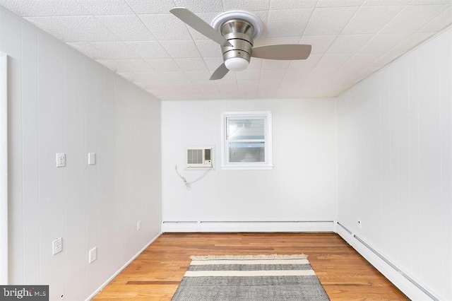 unfurnished room featuring a baseboard radiator, hardwood / wood-style floors, and ceiling fan