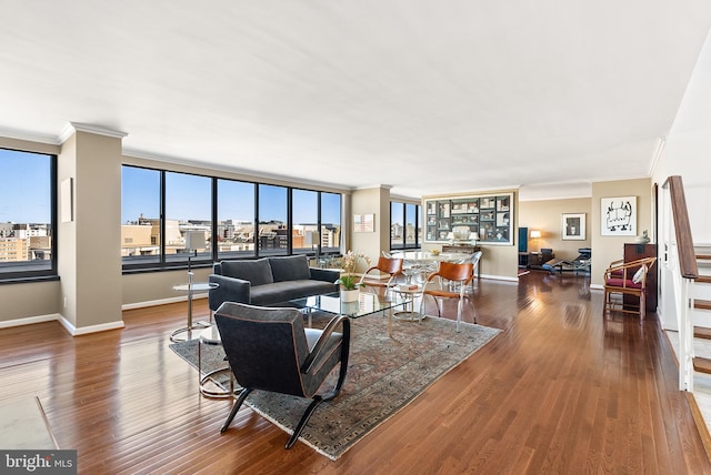 living room featuring dark hardwood / wood-style flooring and ornamental molding