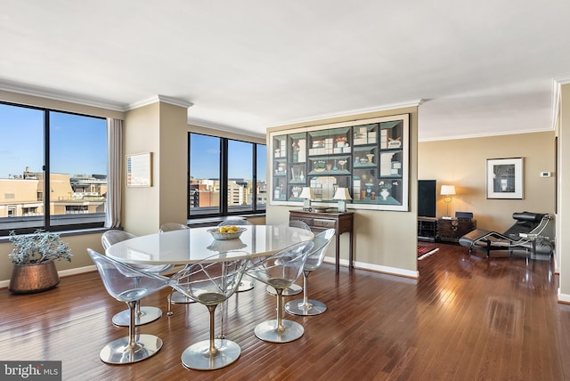 dining room featuring dark hardwood / wood-style floors, ornamental molding, and a wealth of natural light