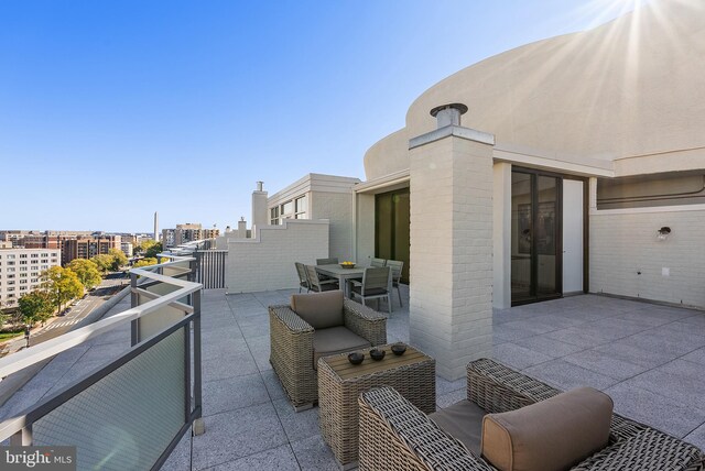 view of patio featuring a balcony