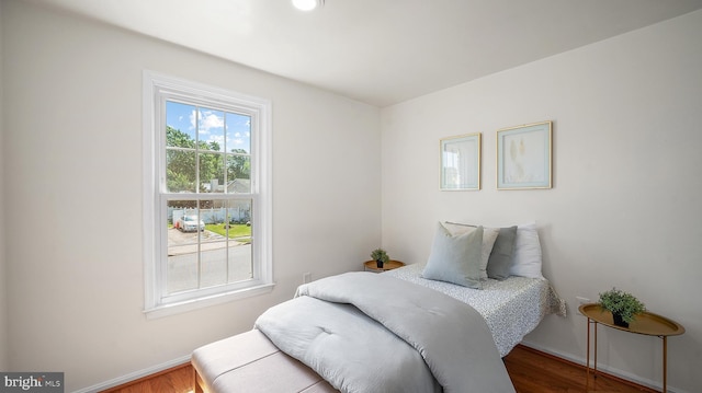 bedroom featuring wood finished floors and baseboards