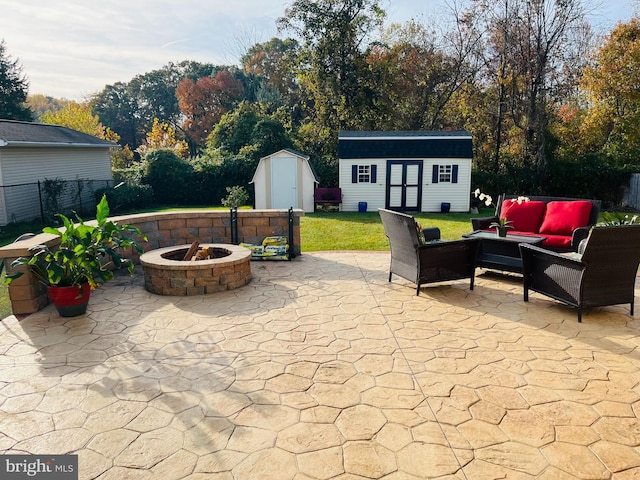 view of patio / terrace with an outdoor living space with a fire pit and a storage shed