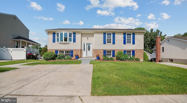 bi-level home featuring brick siding