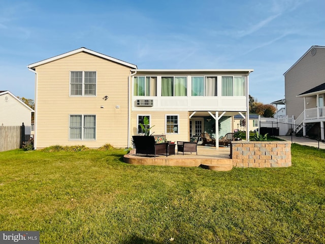 back of property featuring a yard, a patio, and an outdoor hangout area