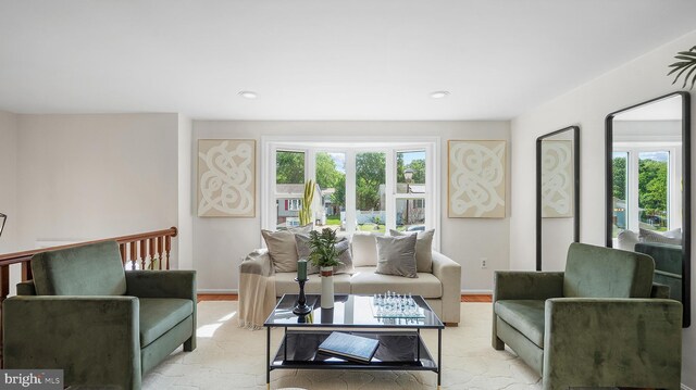 living area with healthy amount of natural light, baseboards, and recessed lighting