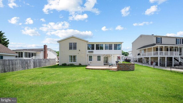 back of house with a patio and a sunroom