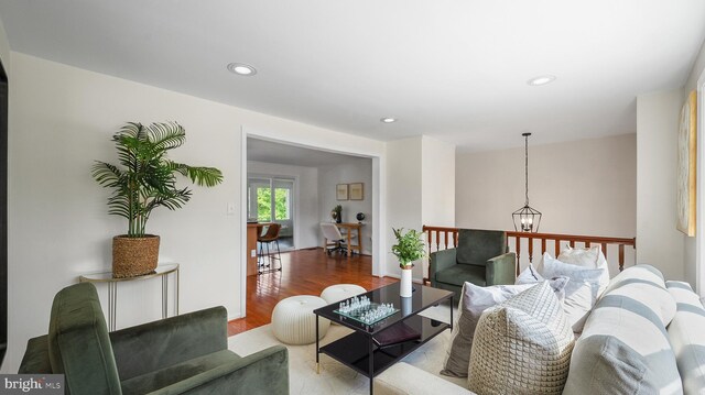 living area with wood finished floors, a chandelier, and recessed lighting
