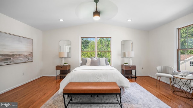 bedroom featuring light wood-type flooring, lofted ceiling, baseboards, ceiling fan, and recessed lighting