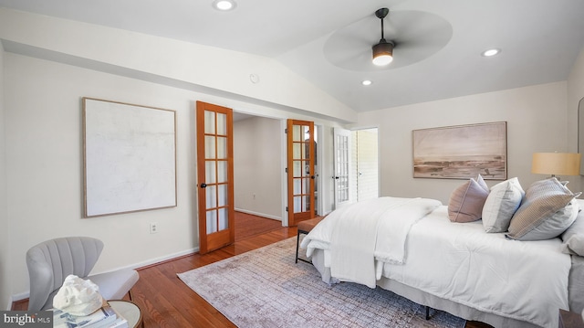 bedroom featuring lofted ceiling, french doors, wood finished floors, baseboards, and recessed lighting