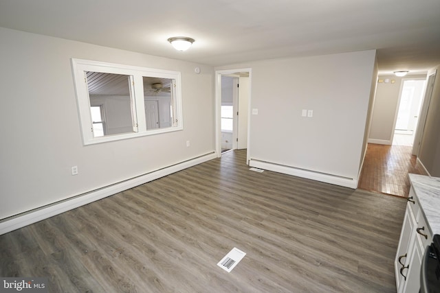 interior space with baseboard heating and dark hardwood / wood-style floors