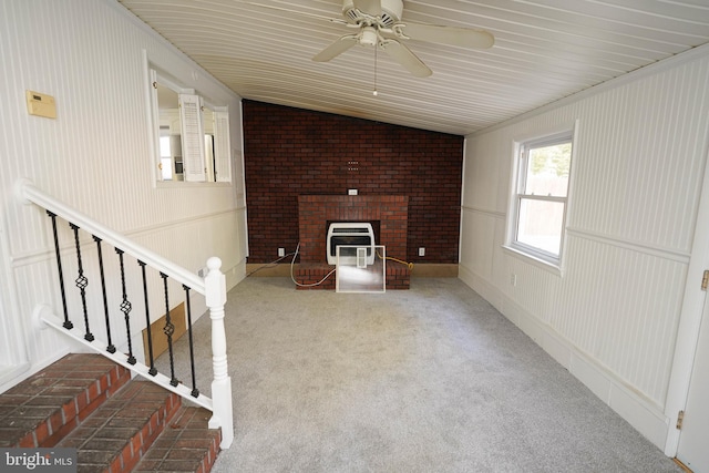 unfurnished living room with vaulted ceiling, carpet flooring, and ceiling fan