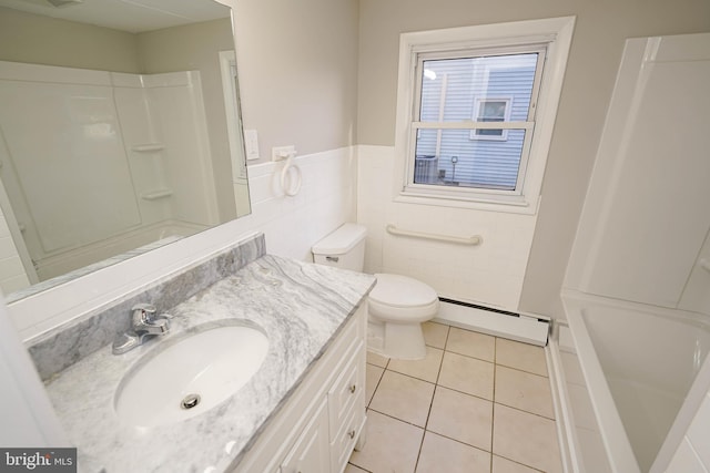 full bathroom with a baseboard radiator, toilet, tile patterned floors, tile walls, and vanity