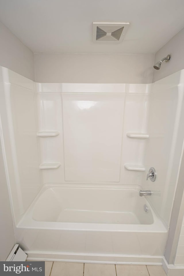 bathroom with tile patterned floors and tub / shower combination