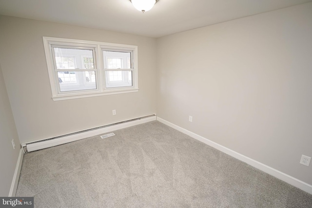 carpeted spare room with a baseboard radiator