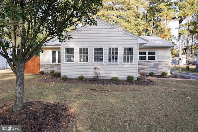 view of side of home with a lawn