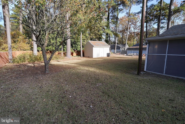 view of yard featuring a storage shed and a sunroom