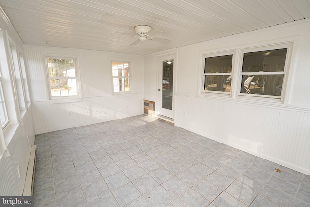 unfurnished sunroom with a baseboard radiator and ceiling fan