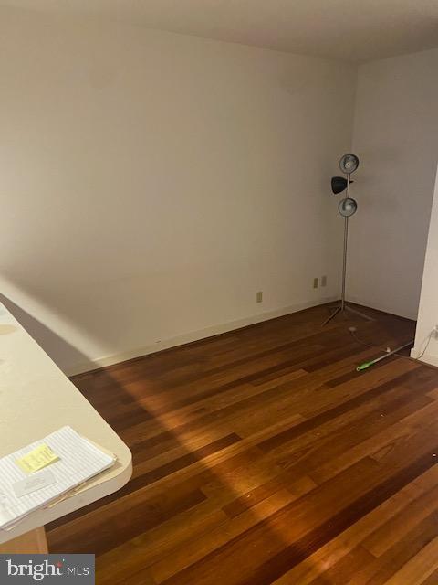 empty room with dark wood-type flooring