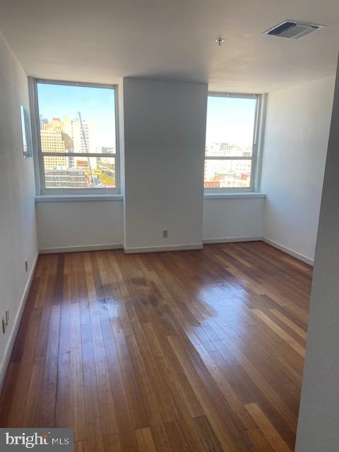 spare room featuring dark hardwood / wood-style flooring