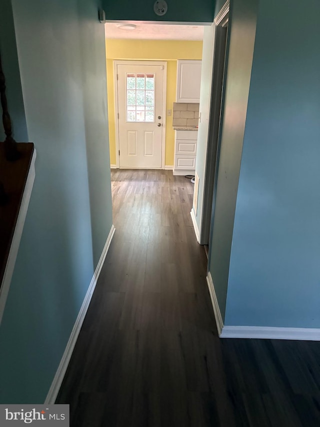 corridor with dark wood-type flooring