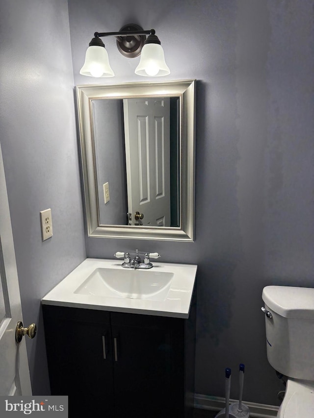 bathroom featuring vanity and toilet