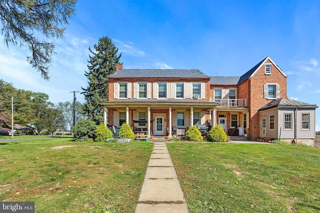 133 Sprecher Rd, Willow Street, PA 17584 - view of front of home featuring a chimney, a front yard, brick siding, and covered porch