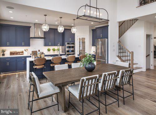 dining room with hardwood / wood-style floors and a chandelier