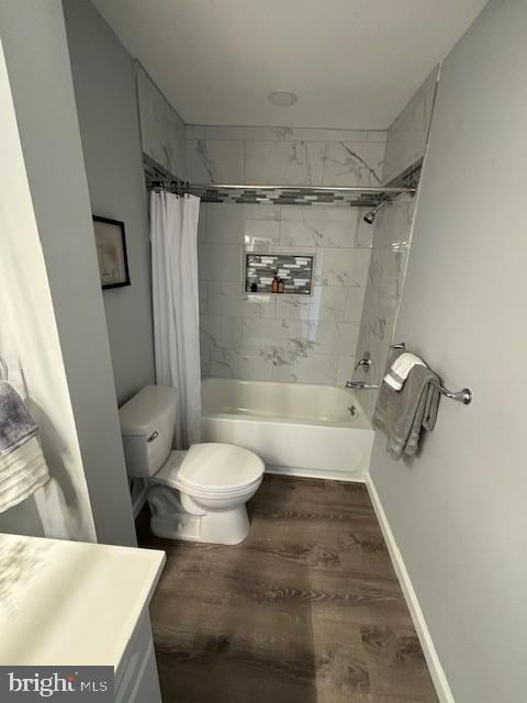 full bathroom featuring toilet, shower / bath combo, vanity, and hardwood / wood-style floors