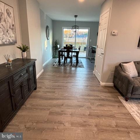 corridor with hardwood / wood-style flooring