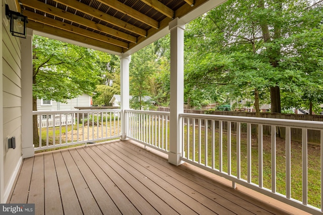 wooden terrace with a lawn