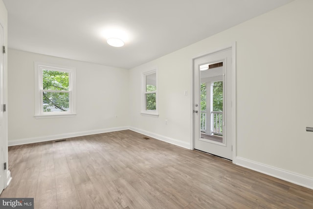 empty room with light hardwood / wood-style floors