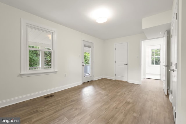 unfurnished room featuring light hardwood / wood-style floors and a healthy amount of sunlight