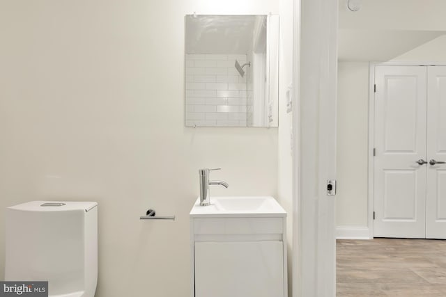 bathroom with vanity, hardwood / wood-style flooring, and a tile shower