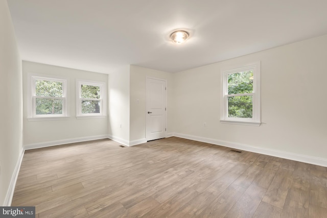 unfurnished room featuring light hardwood / wood-style floors