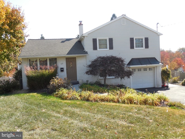 view of front facade with a garage and a front lawn