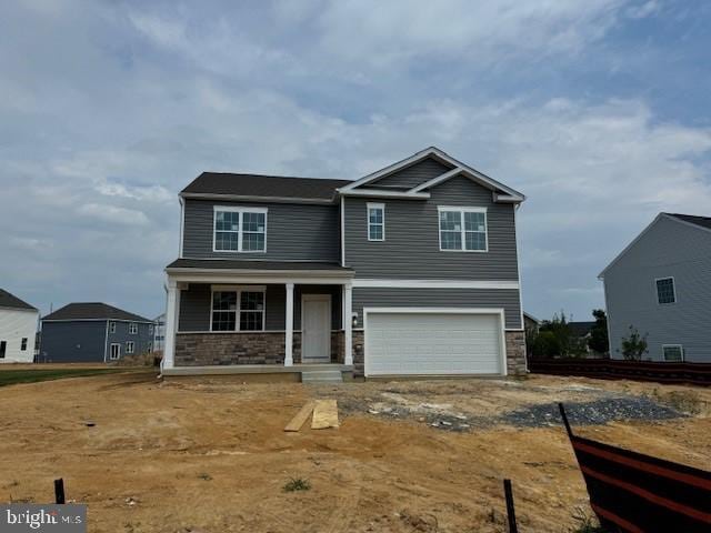 craftsman-style house with covered porch and a garage