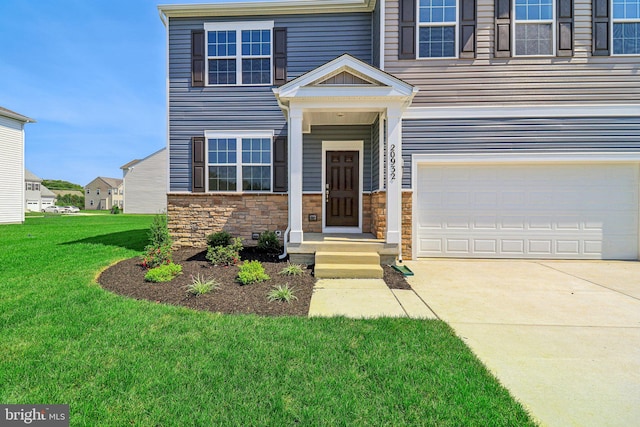 view of front facade featuring a garage and a front lawn