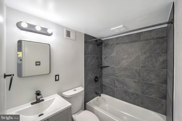 full bathroom featuring toilet, vanity, and tiled shower / bath