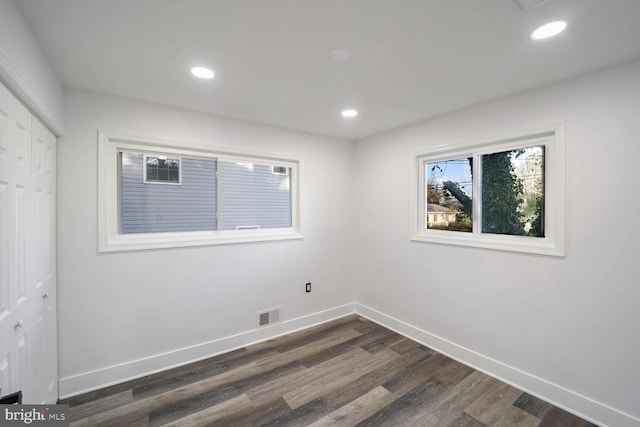 spare room with dark hardwood / wood-style flooring