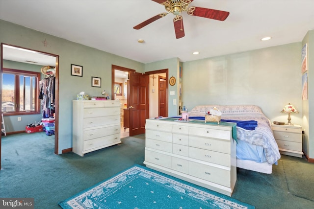 bedroom featuring dark colored carpet, a closet, and ceiling fan