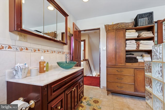 bathroom with vanity, tasteful backsplash, and tile patterned flooring