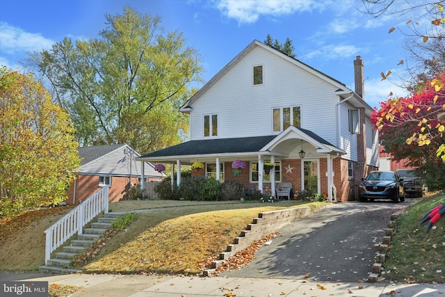 629 Wises Mill Rd, Philadelphia, PA 19128 - view of front of property featuring a chimney, a porch, driveway, brick siding, and stairs