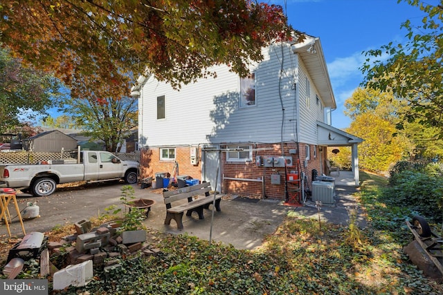 rear view of house with a patio area and central AC