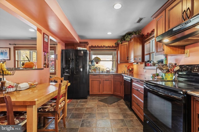 629 Wises Mill Rd, Philadelphia, PA 19128 - kitchen featuring under cabinet range hood, black appliances, plenty of natural light, and visible vents