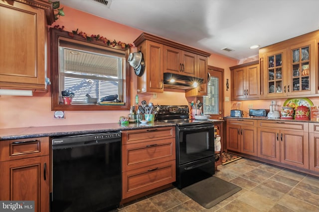 629 Wises Mill Rd, Philadelphia, PA 19128 - kitchen with under cabinet range hood, black appliances, glass insert cabinets, and brown cabinets