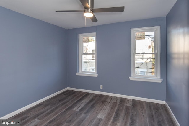 empty room with dark hardwood / wood-style floors and ceiling fan