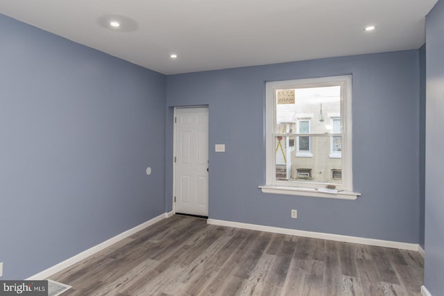 spare room with dark hardwood / wood-style floors