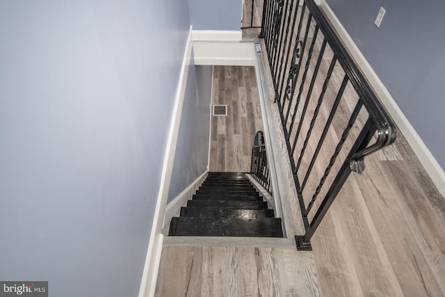 staircase featuring hardwood / wood-style flooring